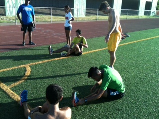 The Chaminade Cross Country team makes time to stretch after an intense track workout.