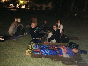 Students hanging out and sleeping on cardboard boxes. Photo by Tawnee Rollerson.