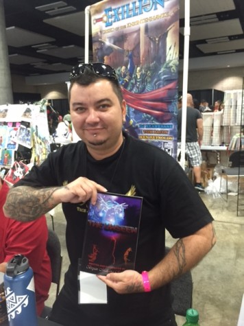 Brian Makana Revell showing off his featured comic of "The Unseen."