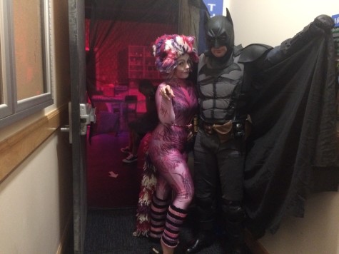 Shannon Gray dressed as a colorful cat, while Ches Bond poses as Batman at the Halloween Movie Night. 