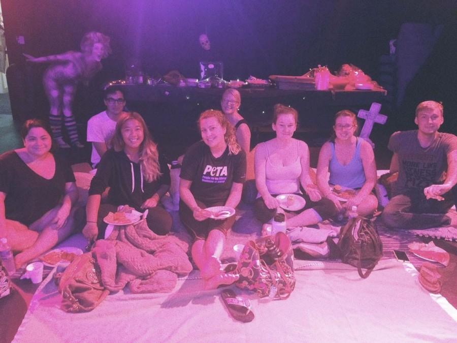 Students sit on blankets and pillows on the floor as they await the showing of the popular 1993 Disney film Hocus Pocus. 