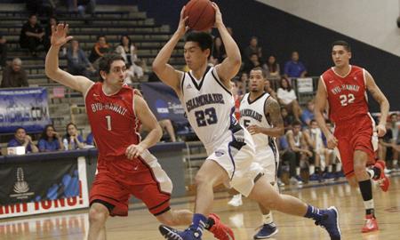 Kevin Hu drives to the hoop aggressively against Pablo Coro of BYU-Hawaii