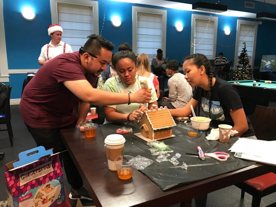 Pono Riddle and his friends help to assemble their gingerbread house. 