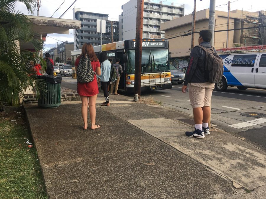 Commuters await the bus and brace themselves for an increase in ride fees. 