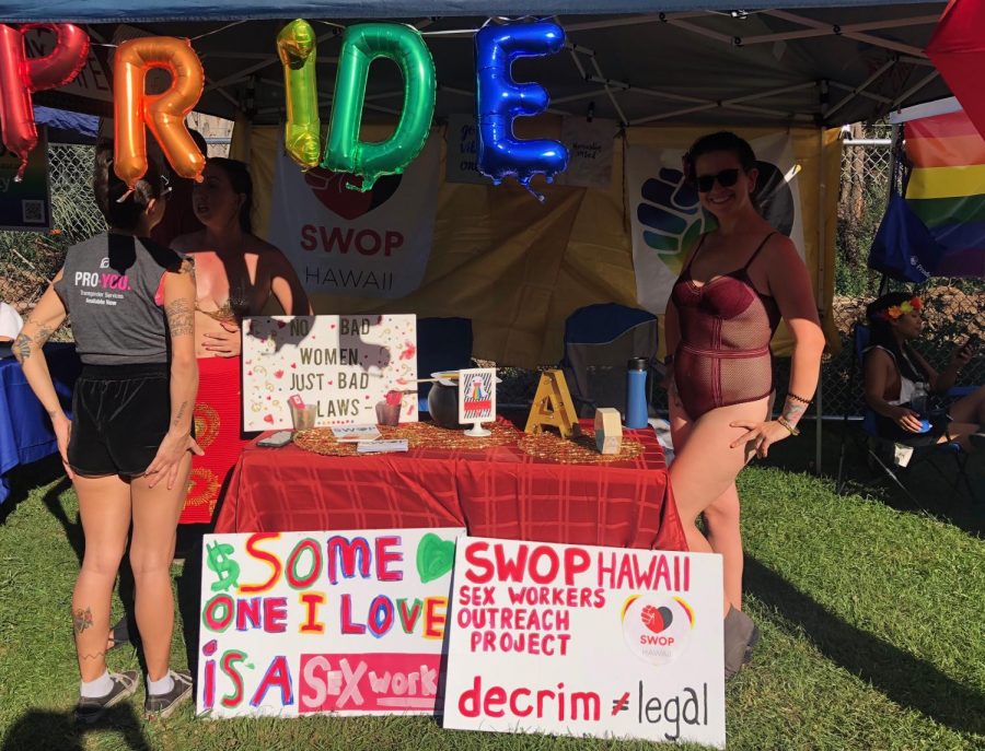 (right) Alivia Levauxxx, 35, founder of SWOP Hawaii, a sex workers outreach project for Hawaii, poses in her booth where she advocated for decriminalization of sex work and educated attendees about the stigmas surrounding sex workers. 
