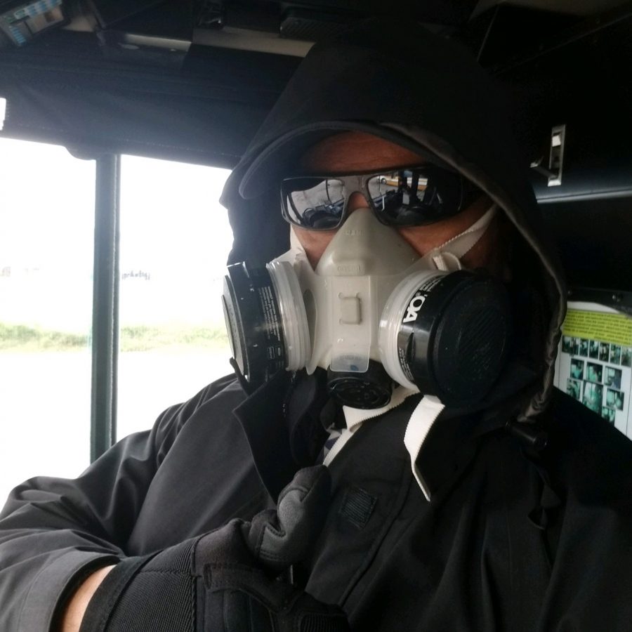 Bus driver takes precaution against Covid-19 with mask and gloves.