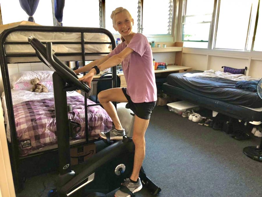 Hannah Harvistol, who is on the Chaminade cross country team, is keeping in shape by riding her exercise bike. 