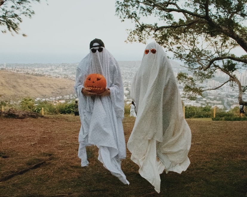 Two spooky Chaminade students try out the sheet ghost costume. 