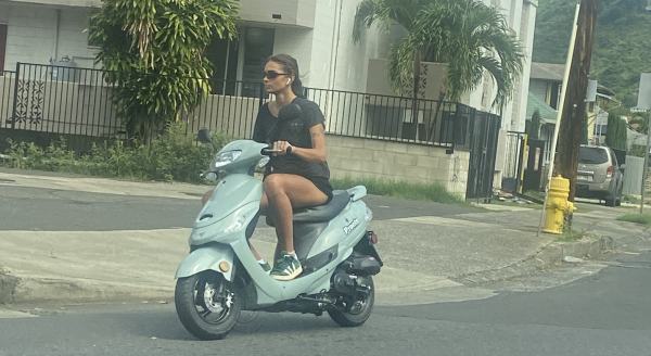 This is what a normal moped rider looks like riding around without a helmet.