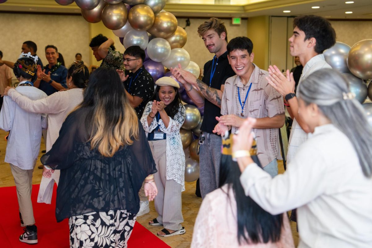 Jasmine Mondelo (center) joins fellow Chaminade students cheer as they welcome participants for the 2025 West O'ahu Unity Prom. (Photo courtesy of Chaminade University Communications and Marketing)