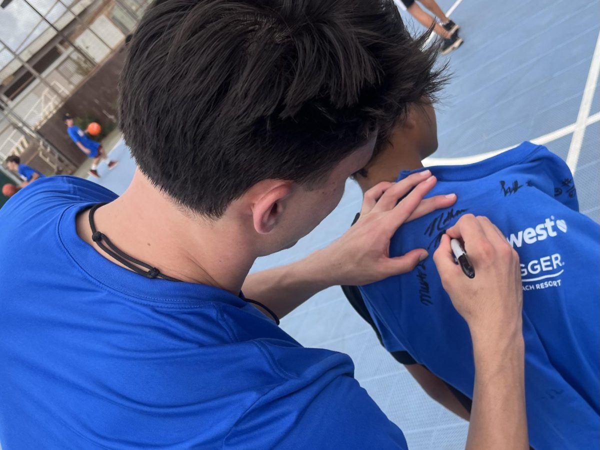 Chaminade guard Nathan Medina made a kid's day by signing his shirt after Maui Invitational Hoops Clinic. 