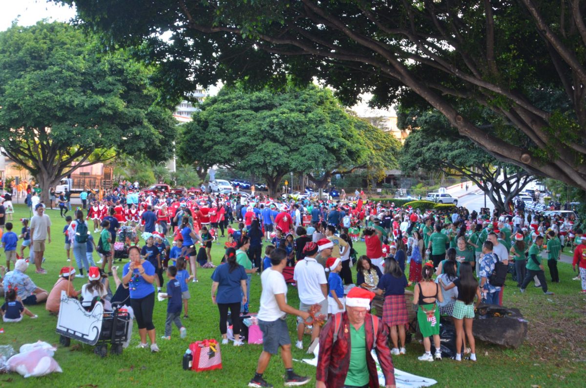 The Kaimuki community people marching in the parade gathered in the front lawn of Chaminade practicing and gettin prepared to walk bringing everyone together with Christmas spirit.