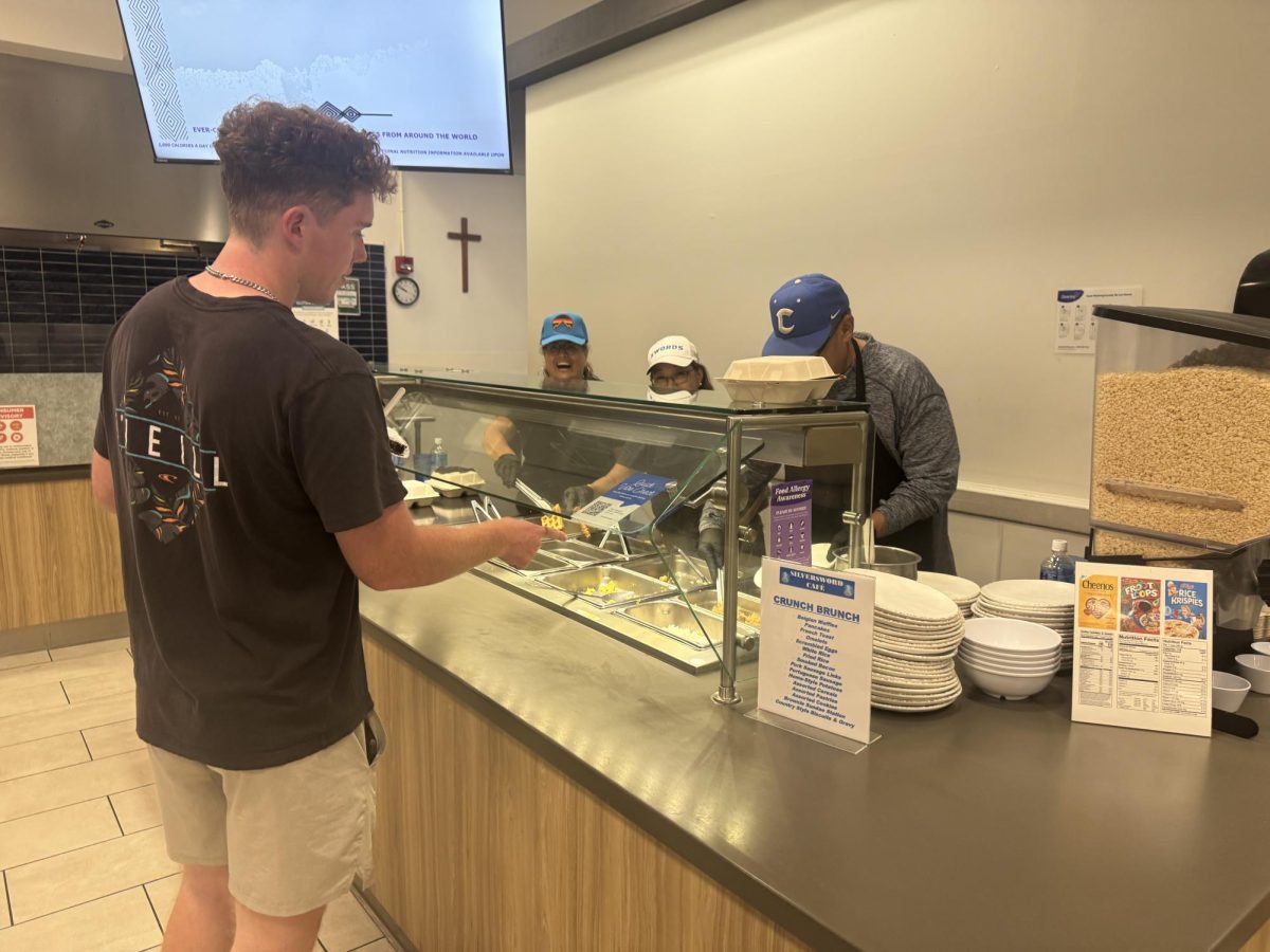 A Chaminade University student is served breakfast during Crunch and Brunch on Tuesday night, a long-running tradition that offers students a break and a meal before finals week.